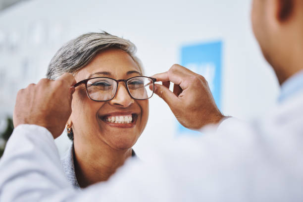 istockphoto-1627701437-612x612 Optometry, smile and woman with prescription glasses, optician and helping client with product. Female person, employee and optometrist assist with eyewear, clear vision and buying new spectacles
